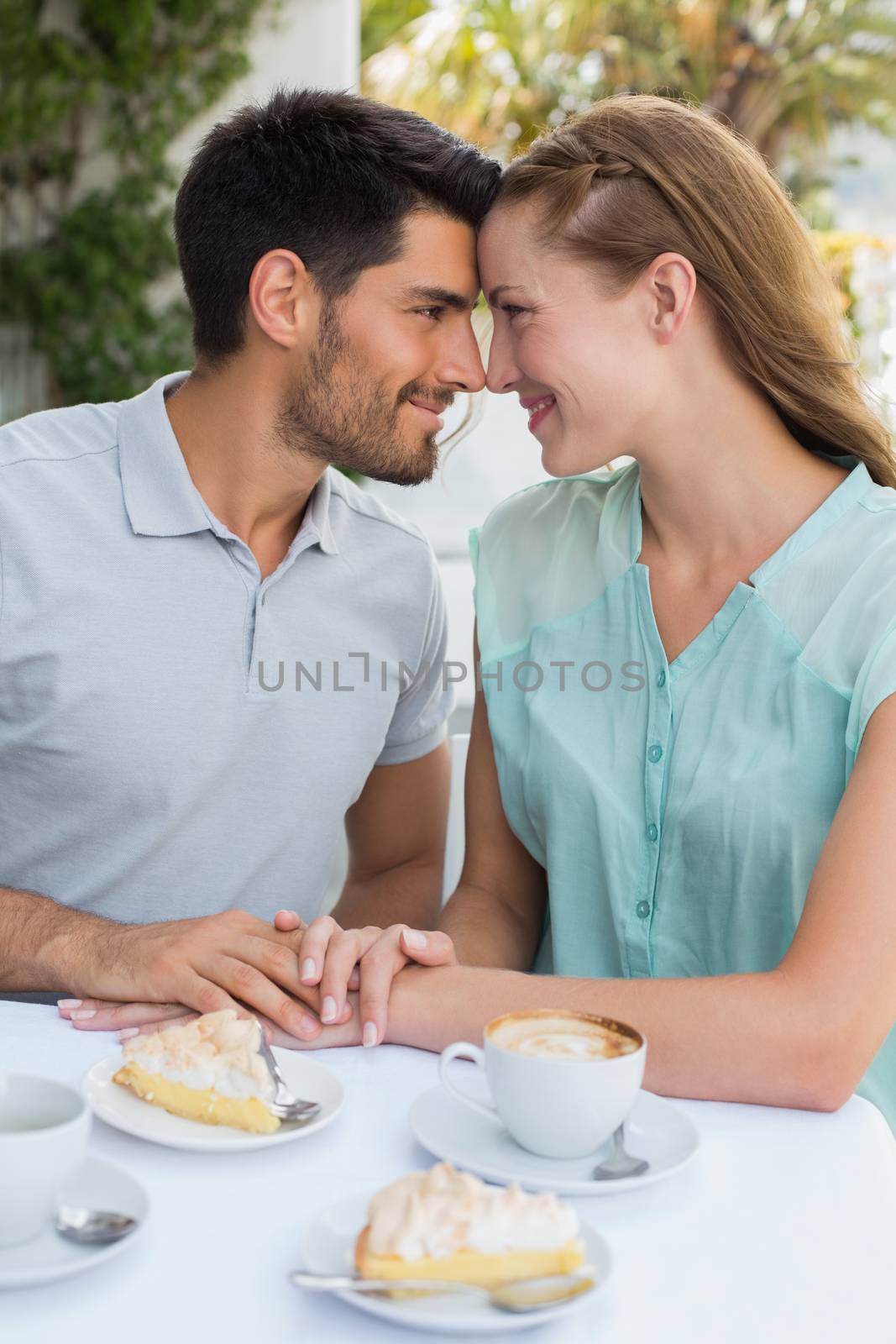 Couple looking at each other at coffee shop by Wavebreakmedia