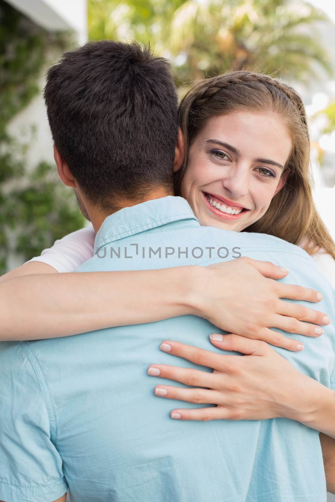 Close-up portrait of a loving young couple embracing outdoors