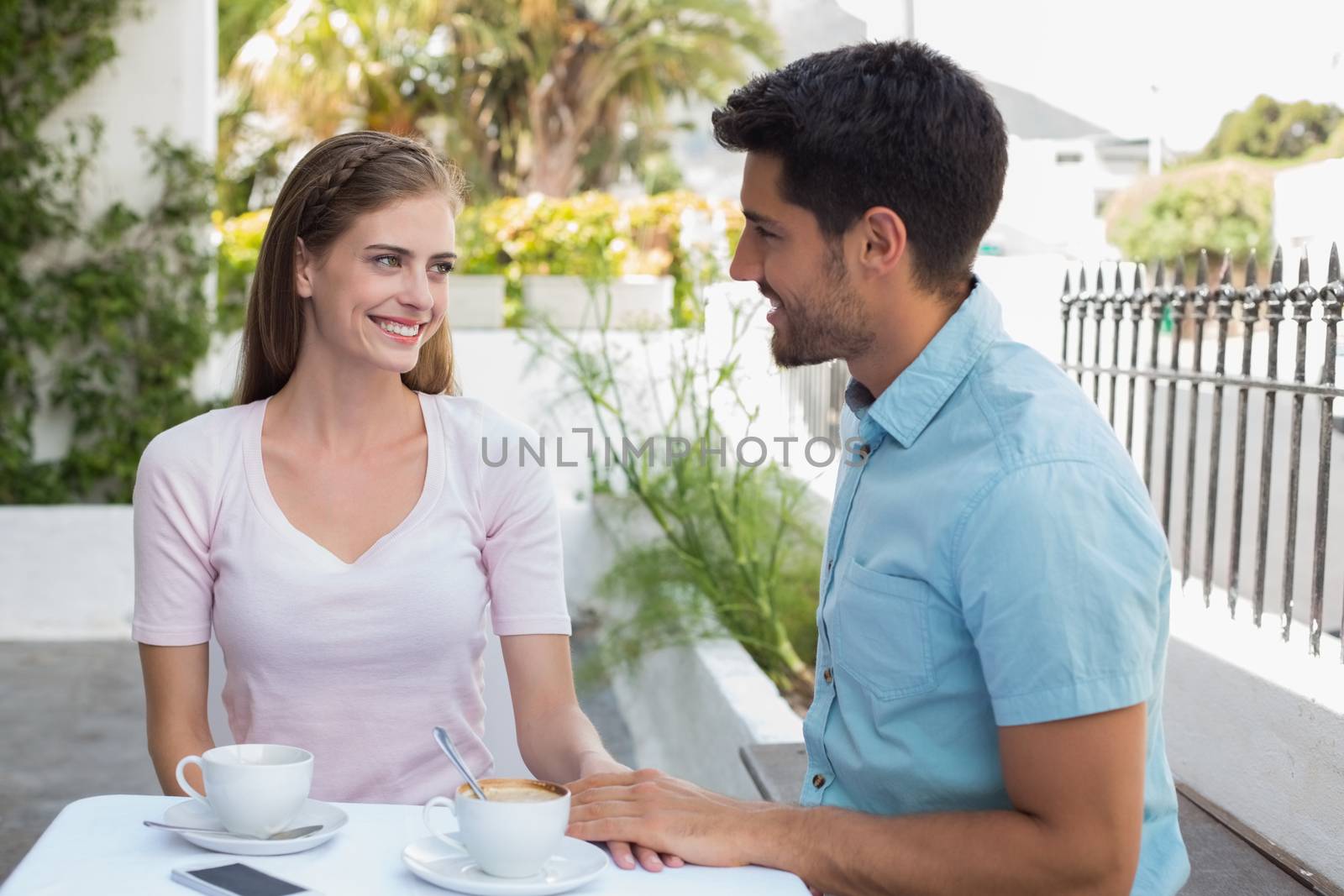 Romantic young couple at coffee shop by Wavebreakmedia