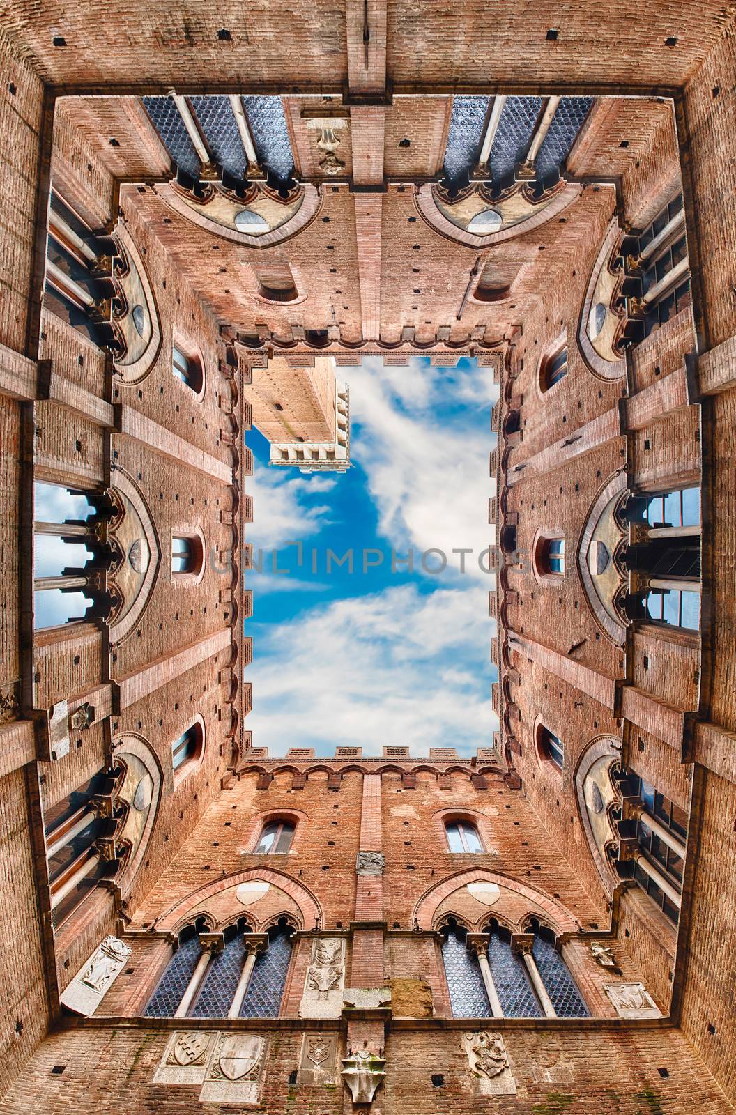 Scenic view from the bottom at the patio of Palazzo Pubblico, major landmark in Siena, Italy