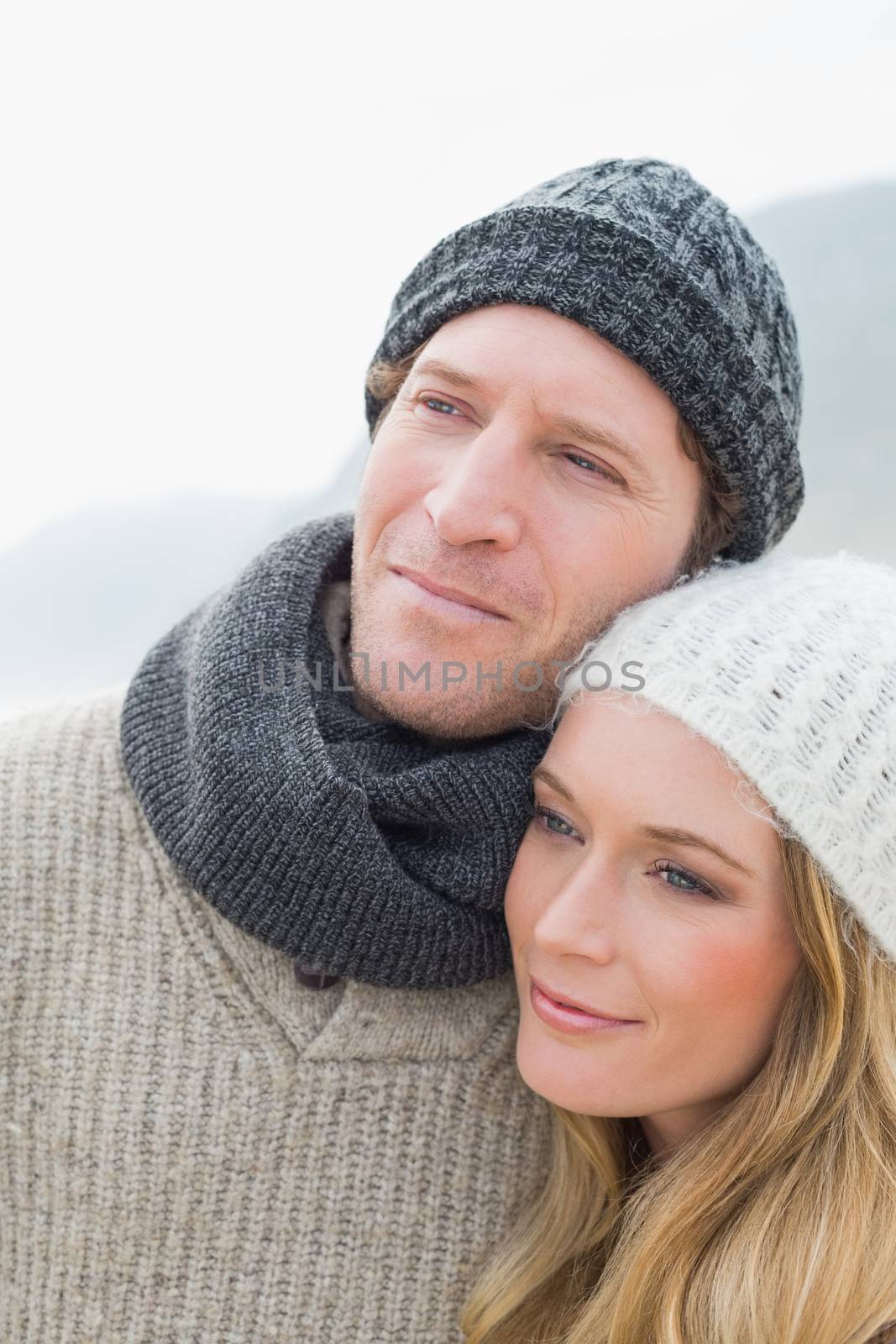 Closeup of a romantic young couple in warm clothing outdoors