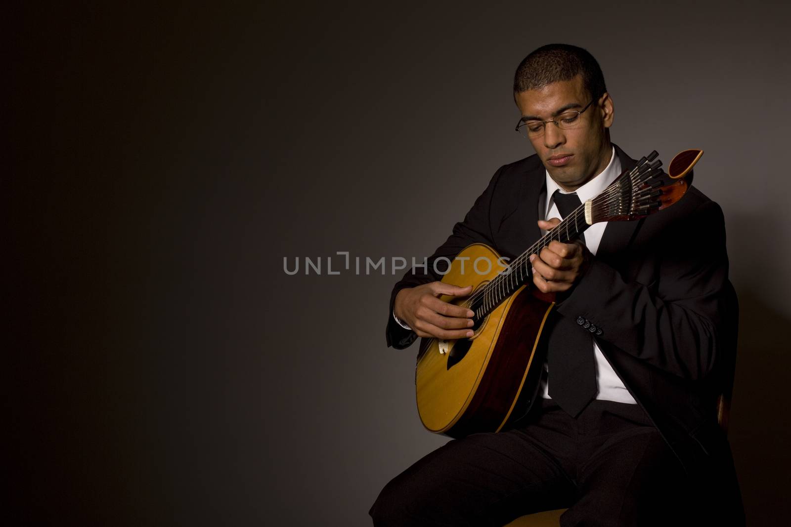 fado musician with a portuguese guitar, studio