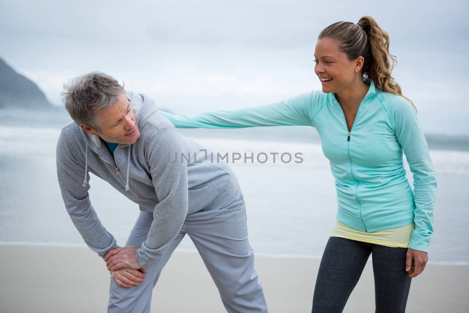 Romantic couple exercising on beach