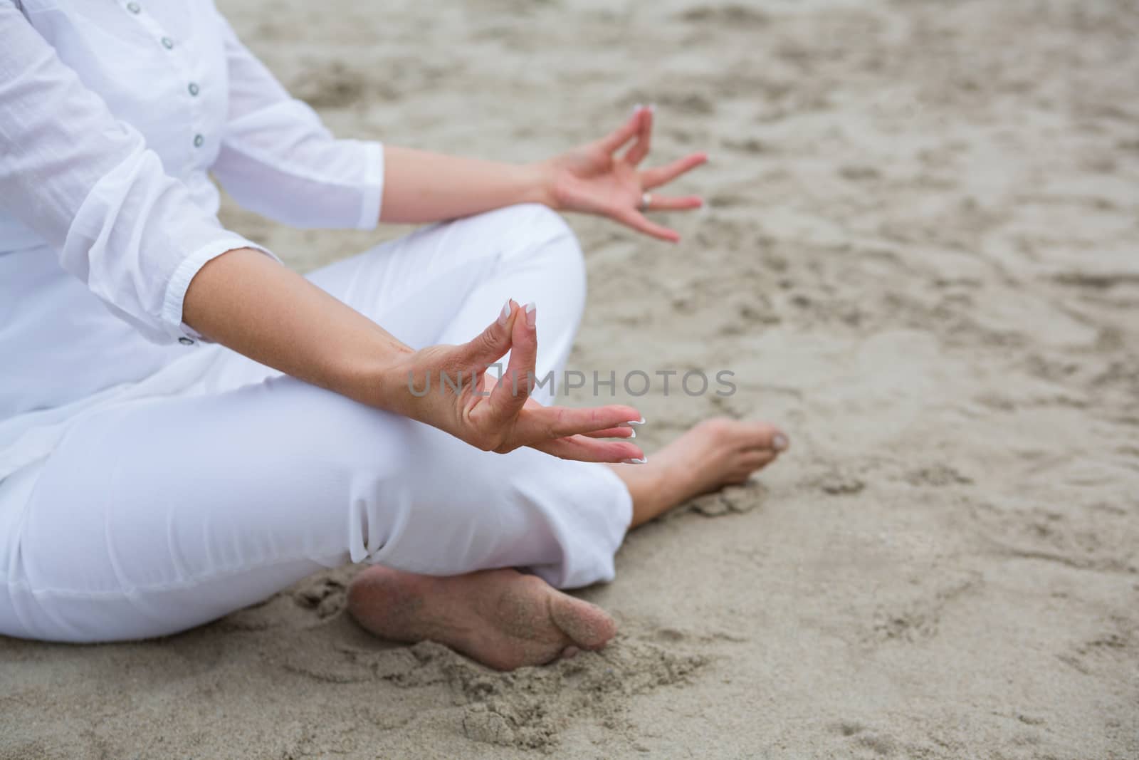 Mid section of woman performing yoga by Wavebreakmedia