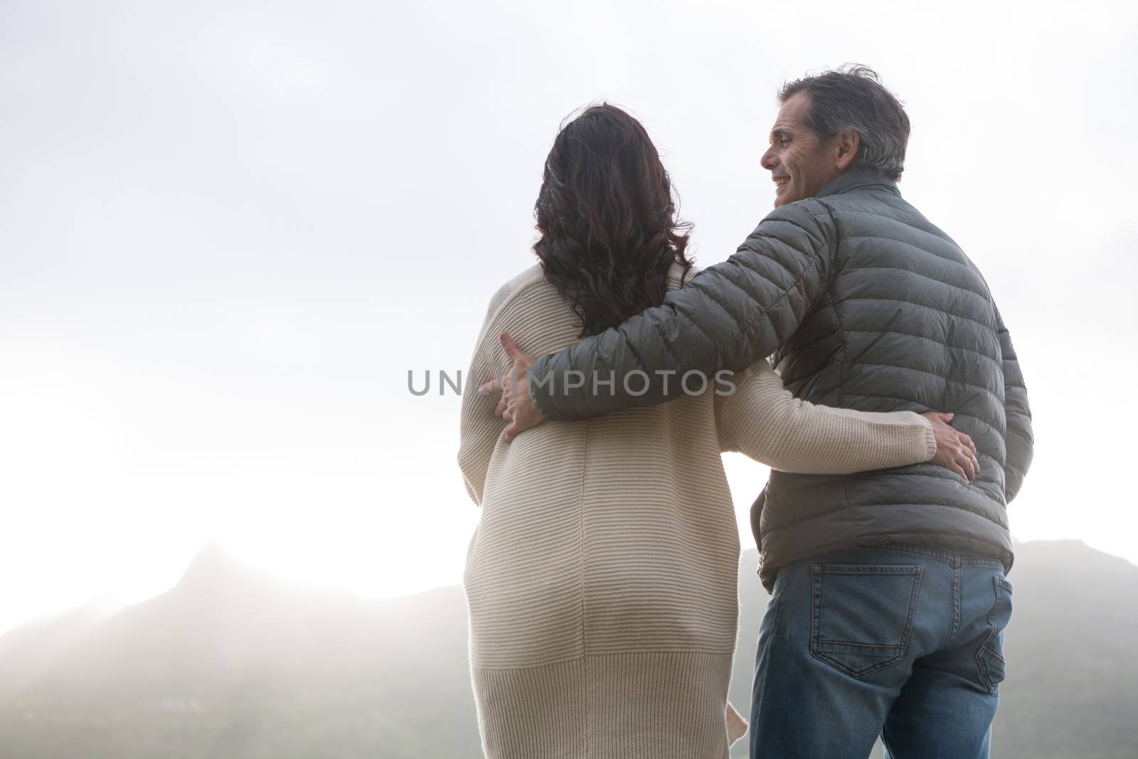 Romantic couple embracing each other on beach by Wavebreakmedia