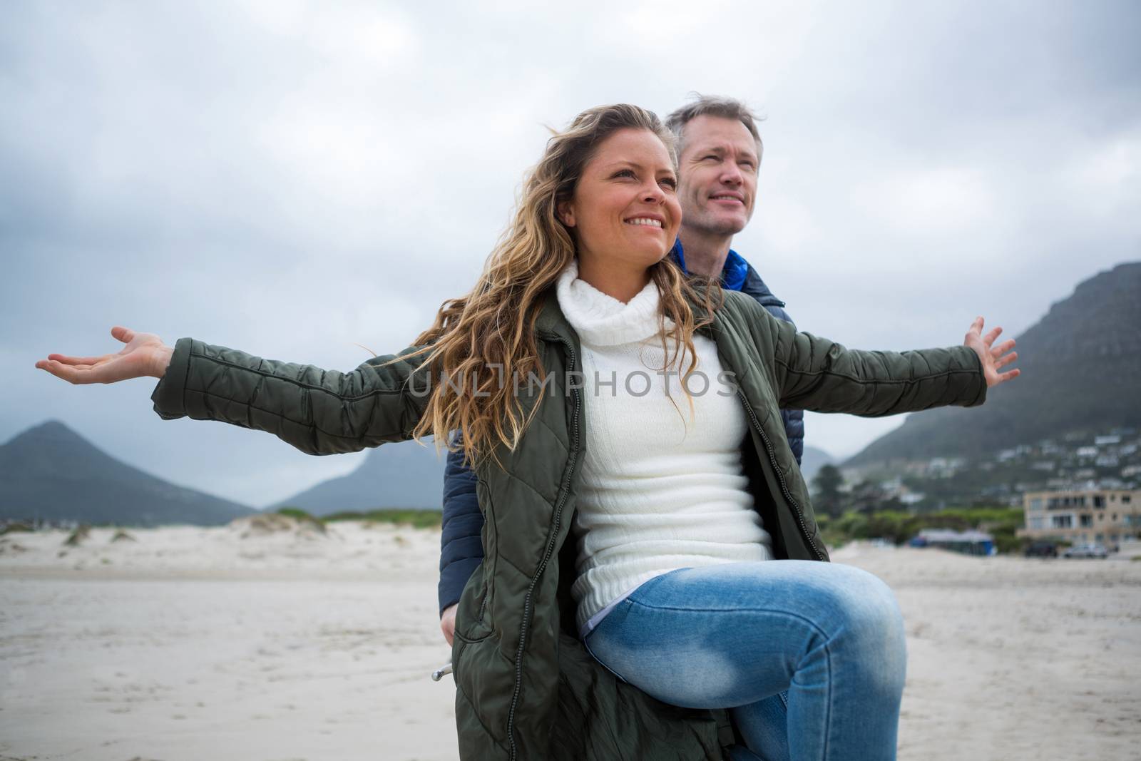 Romantic couple enjoying on beach during winter