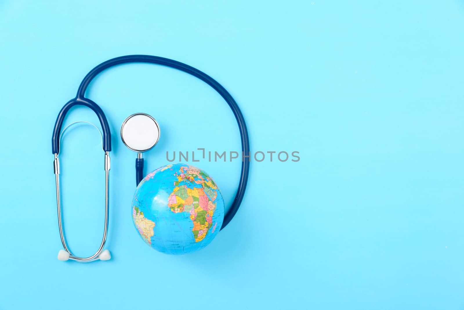 World health day concept, Stethoscope, globe on blue background with copy space. Global health care