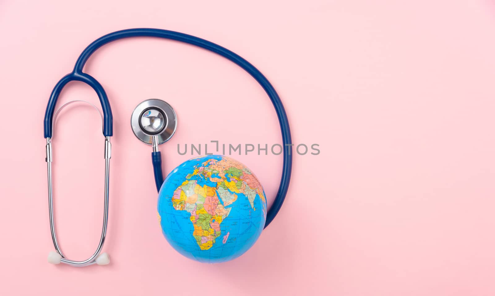 World health day concept, Stethoscope, globe on pink background with copy space. Global health care