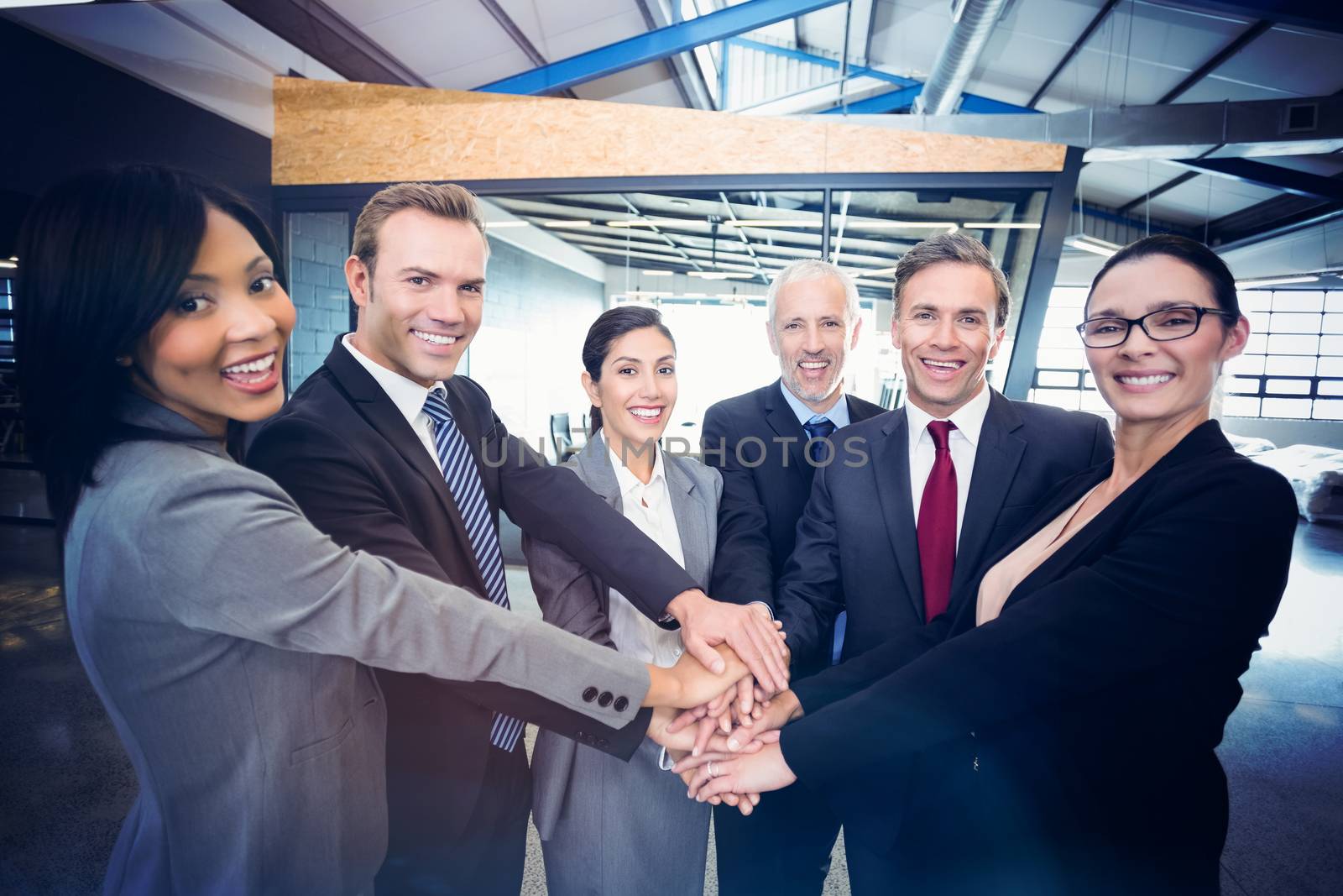 Businesspeople hands stacked over each other in office
