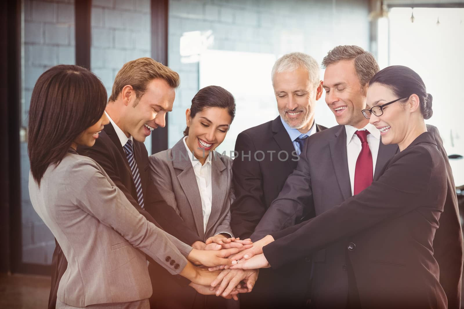 Business people hands stacked over each other in office