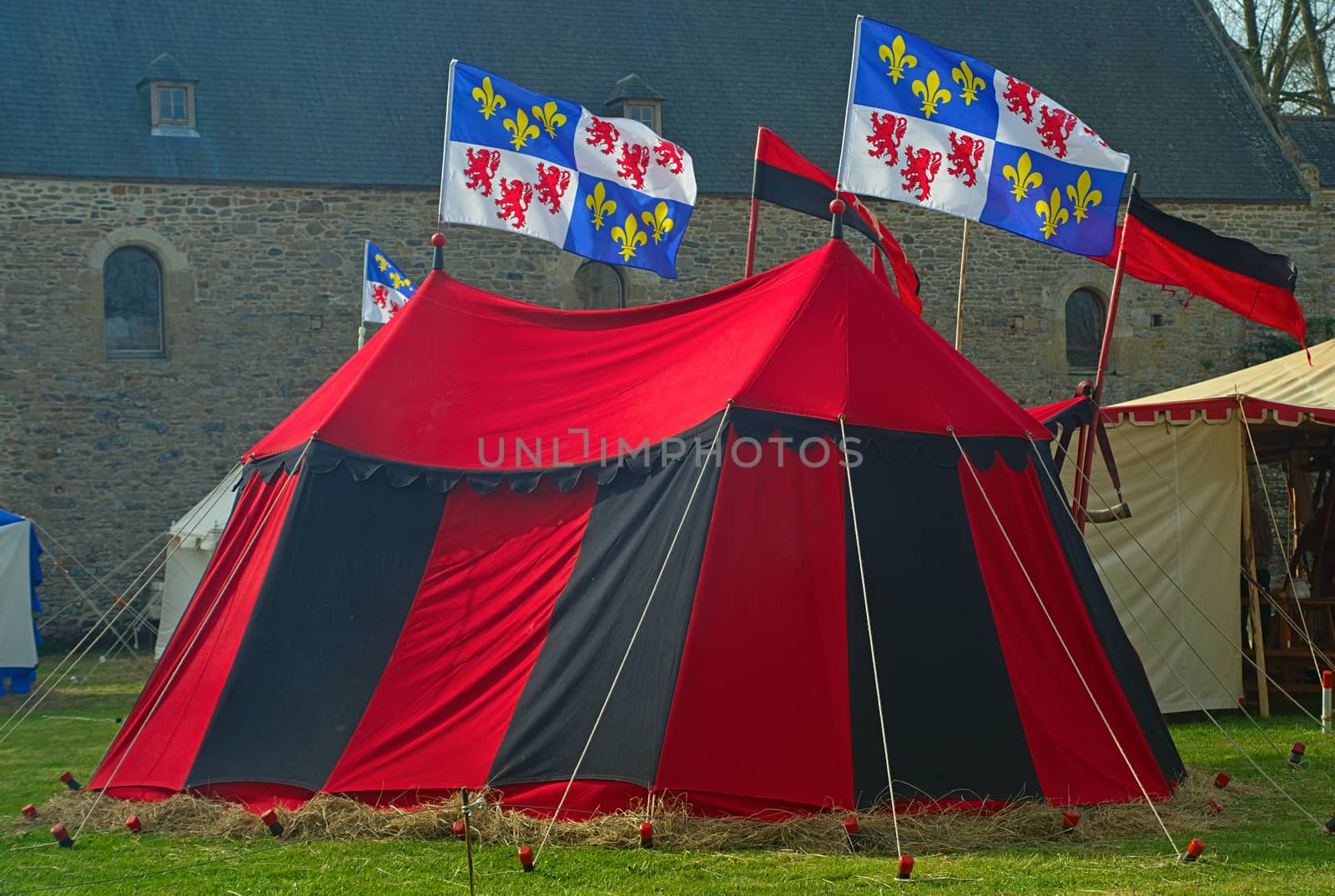 Medieval red and black war tent with normandy flags waving