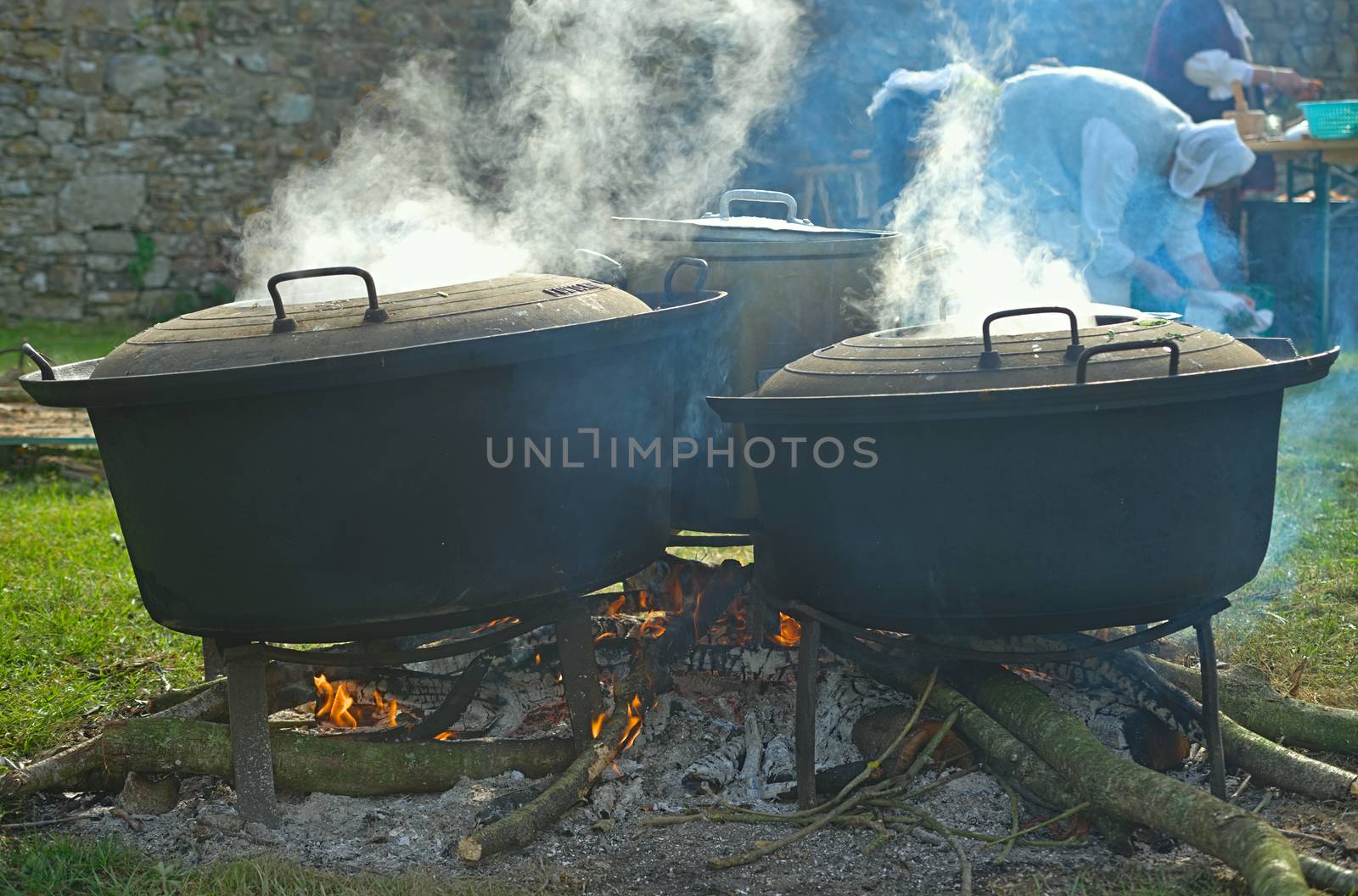 Medieval style of preparing food with three pots cooking on wood by sheriffkule