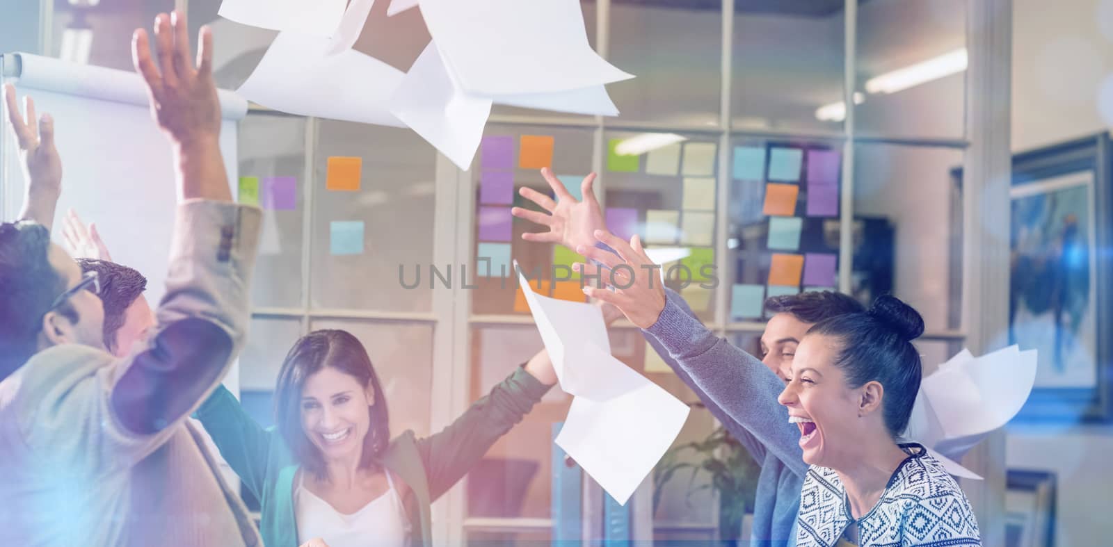 Group of business people celebrating by throwing their business papers in the air