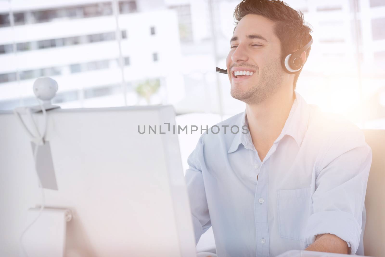 Happy designer laughing during an online communication by Wavebreakmedia