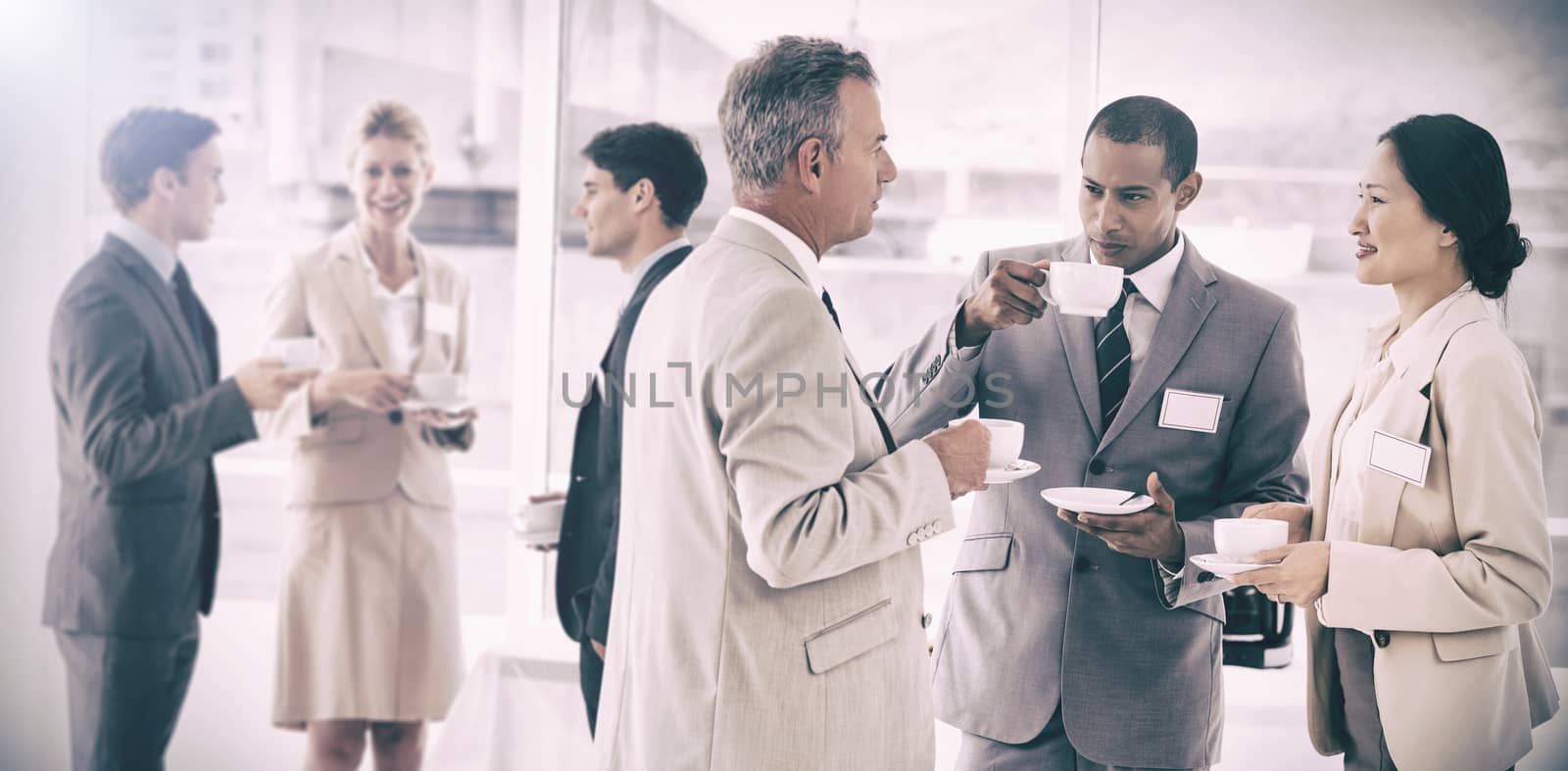 Business people chatting and drinking coffee at a conference by Wavebreakmedia