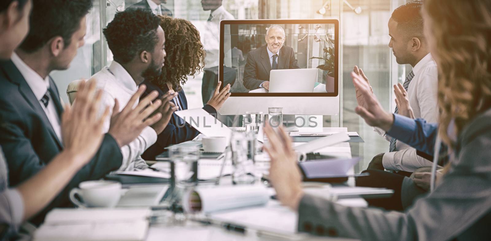 Business people looking at screen during video conference in office