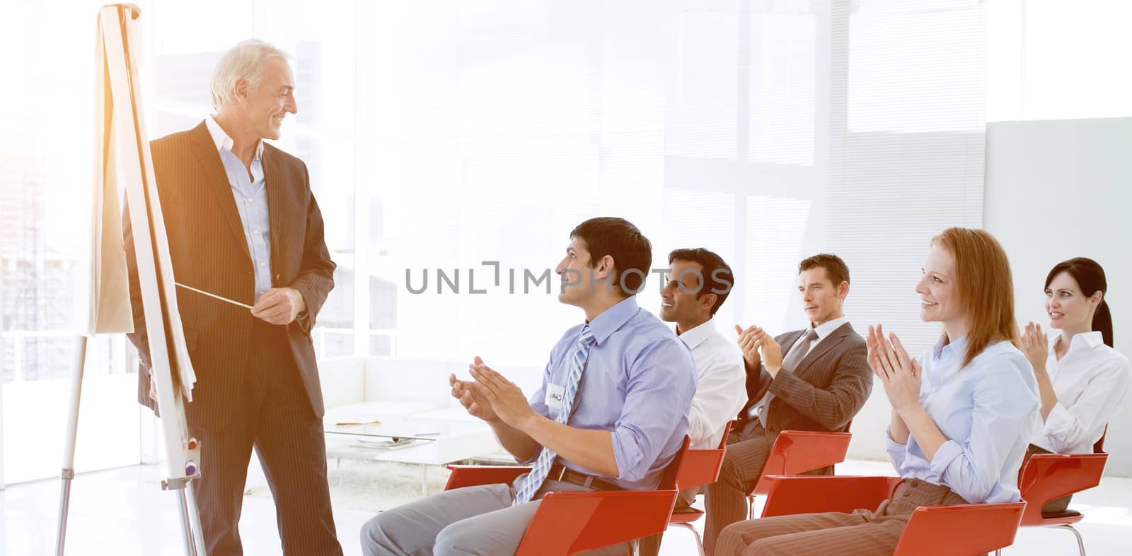 Business people applauding at the end of a conference in the office