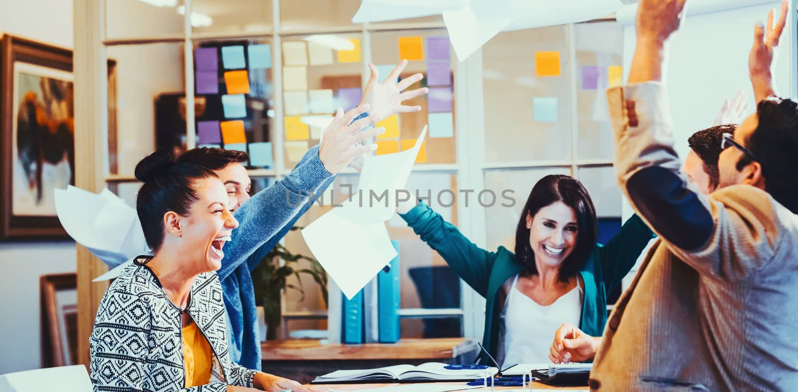 Group of business people celebrating by throwing their business papers in the air