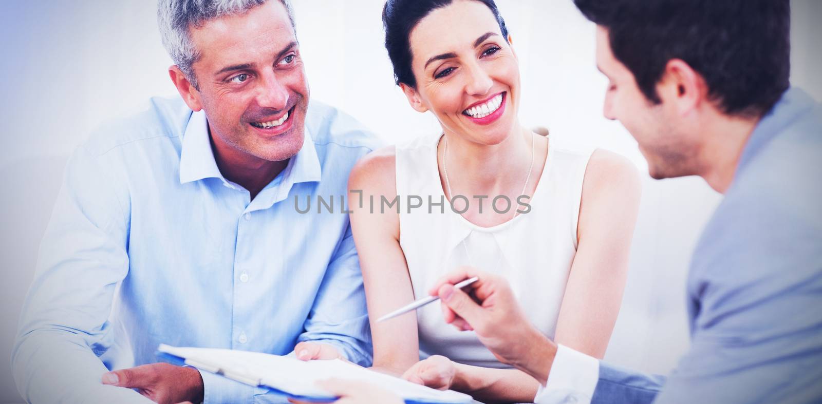 Business people talking together on sofa at office