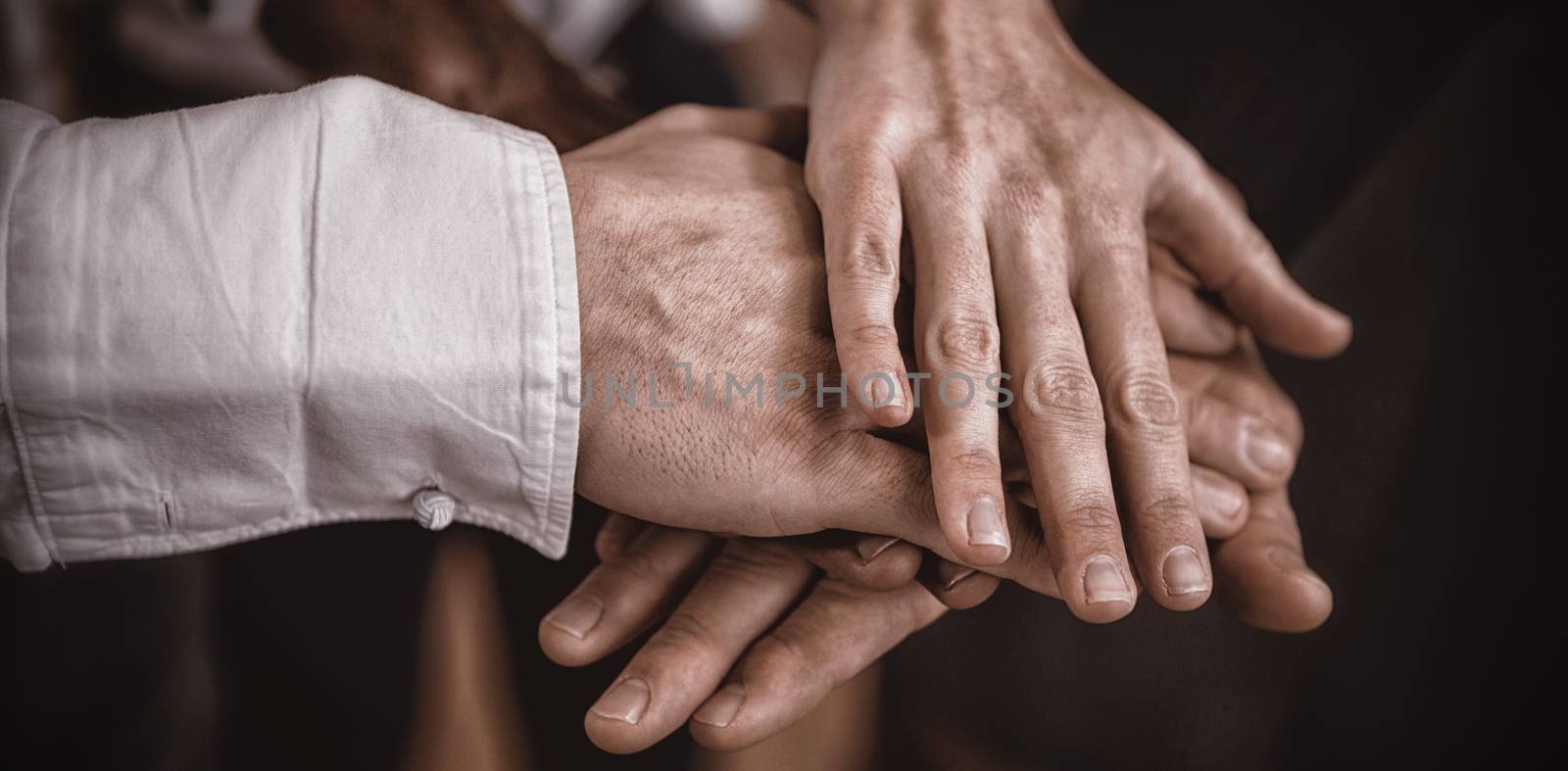 Cropped image of business people with hand stack in office