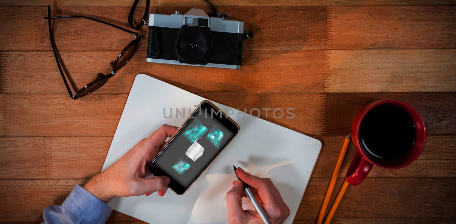 Technology interface  against overhead view of businesswoman writing in personal organizer while using mobile phone