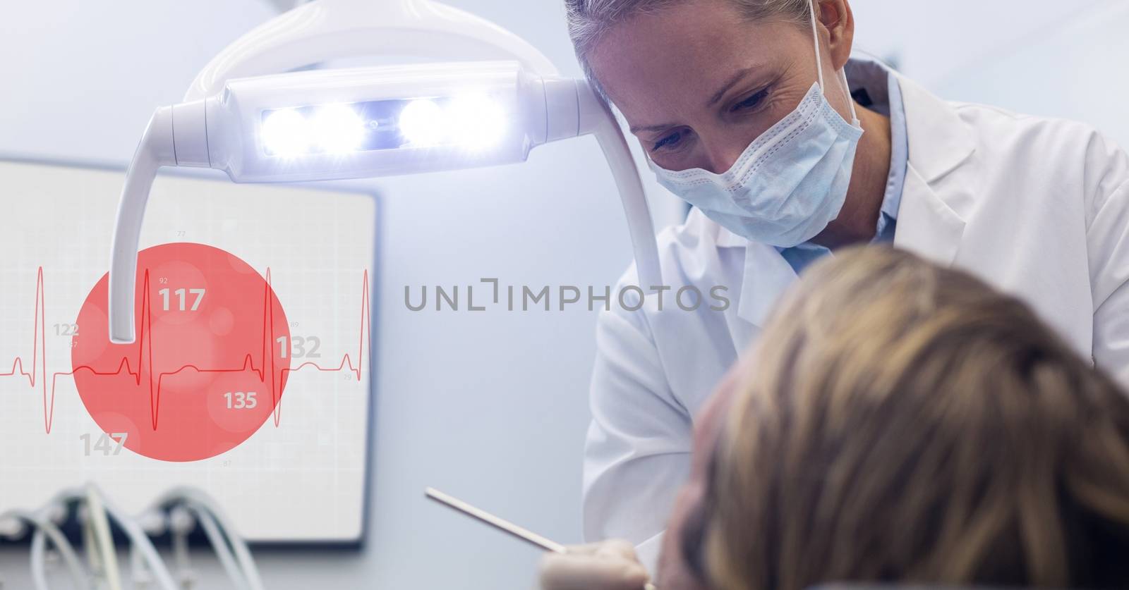 Female dentist checking patient teeth in hospital