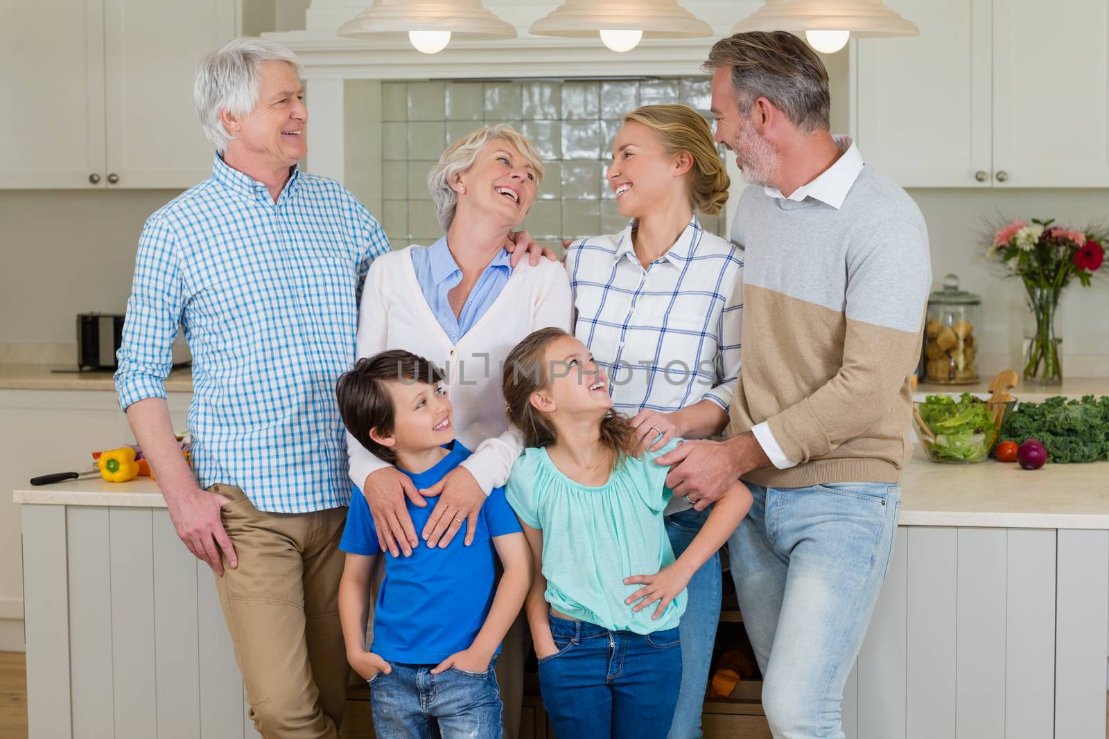 Happy family interacting with each other in kitchen at home