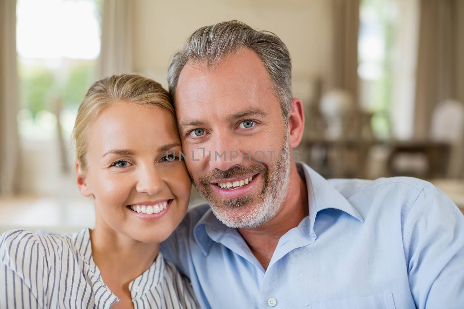 Romantic couple smiling in living room by Wavebreakmedia