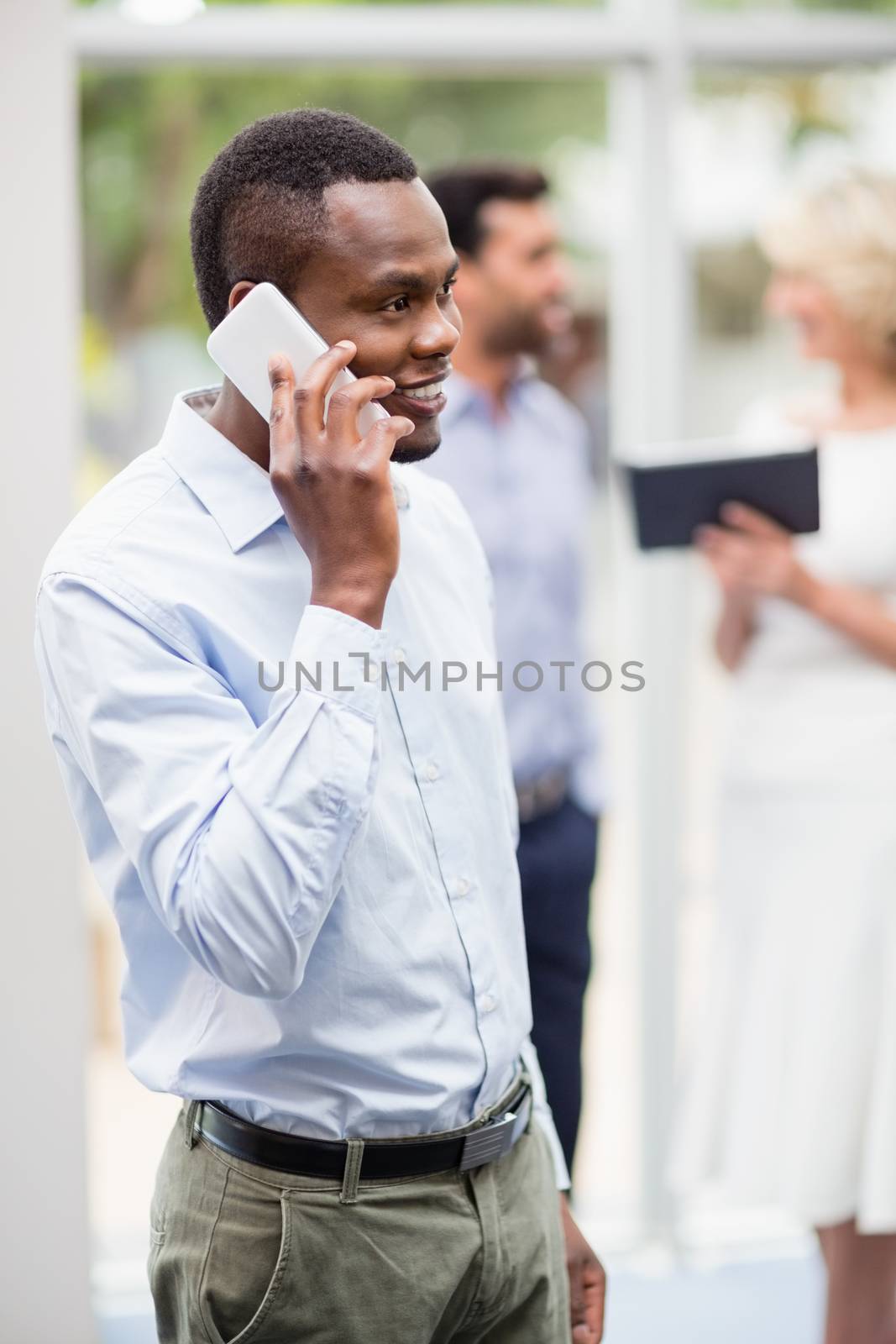 Happy businessman talking on mobile phone