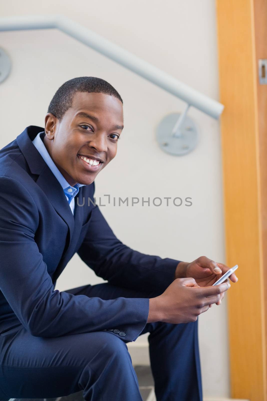 Portrait of a businessman holding mobile phone