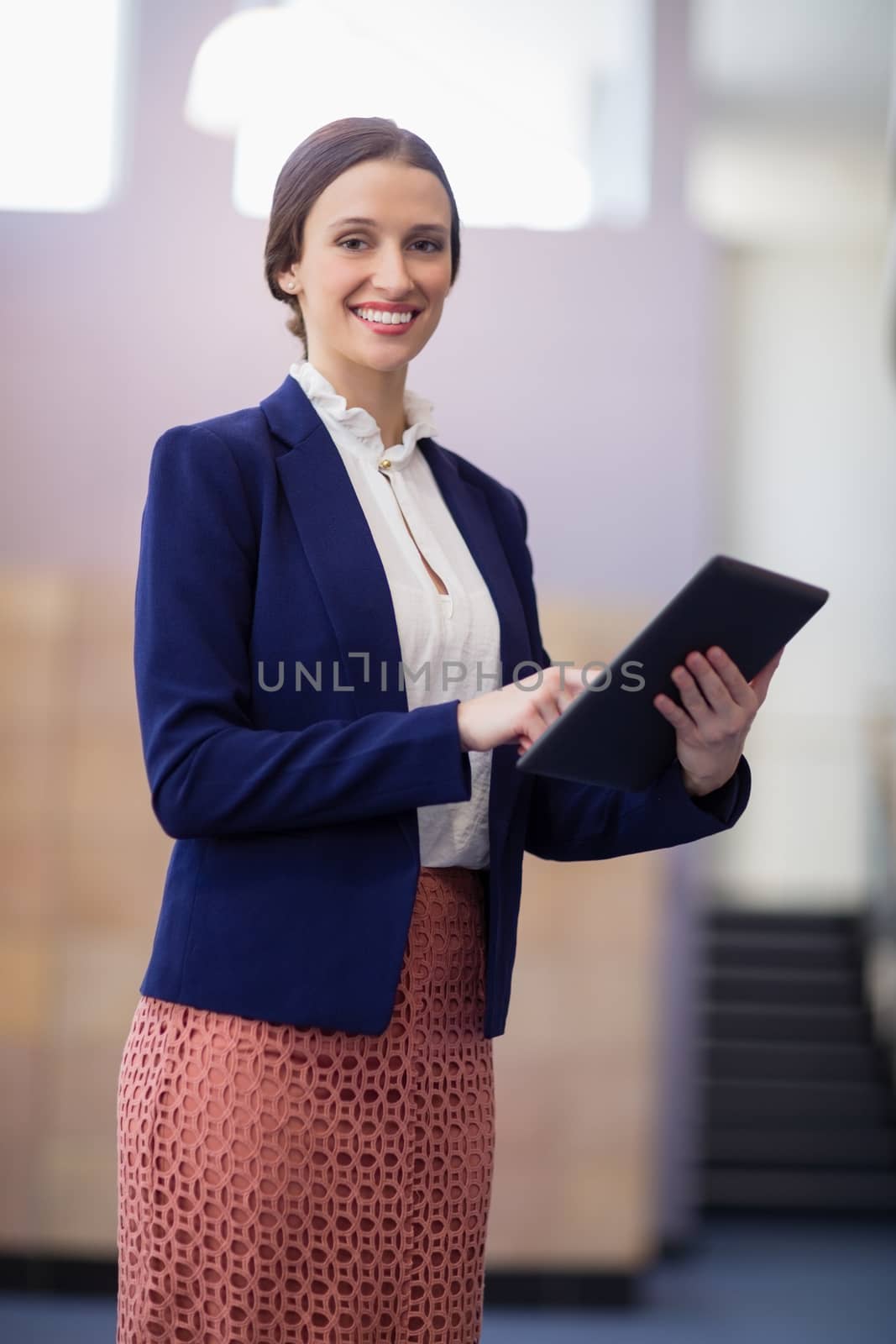 Portrait of a businesswoman holding digital tablet at conference centre