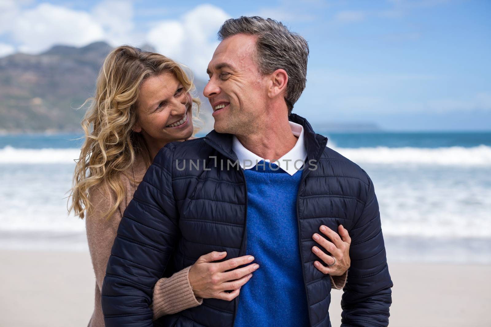 Mature couple enjoying on the beach by Wavebreakmedia