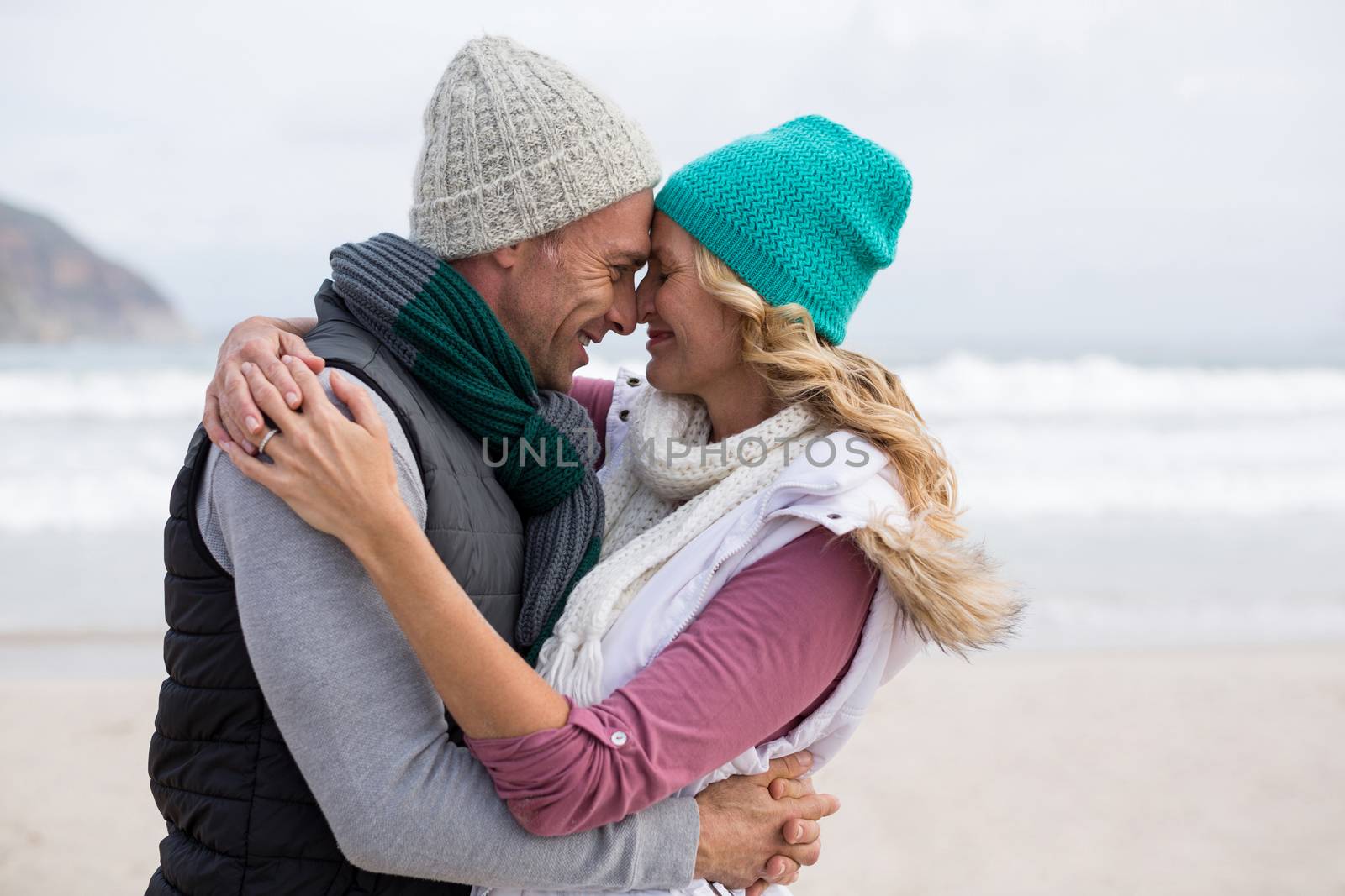 Mature couple embracing each other on the beach by Wavebreakmedia