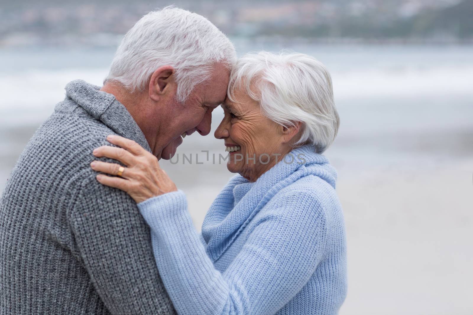 Senior couple standing together on the beach by Wavebreakmedia
