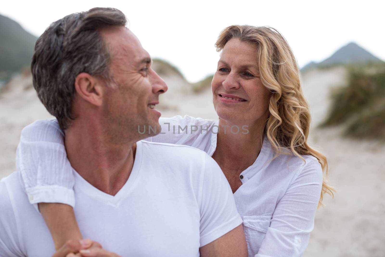 Romantic mature couple standing together on the beach