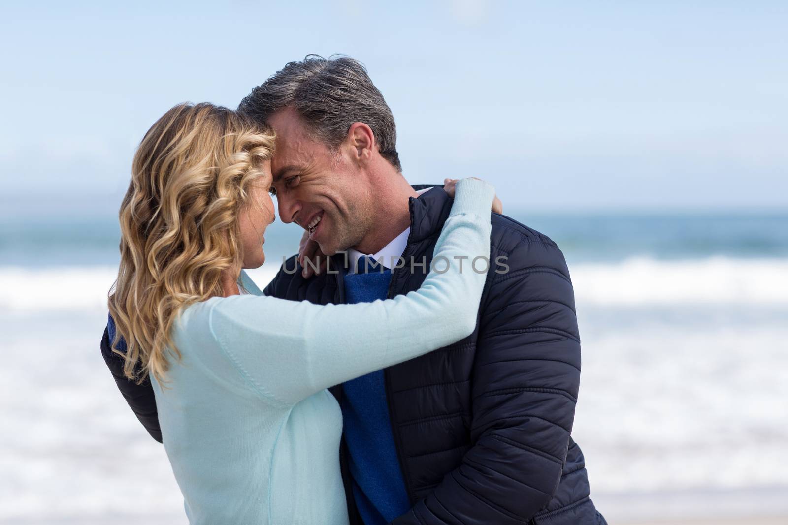 Romantic mature couple embracing each other on the beach