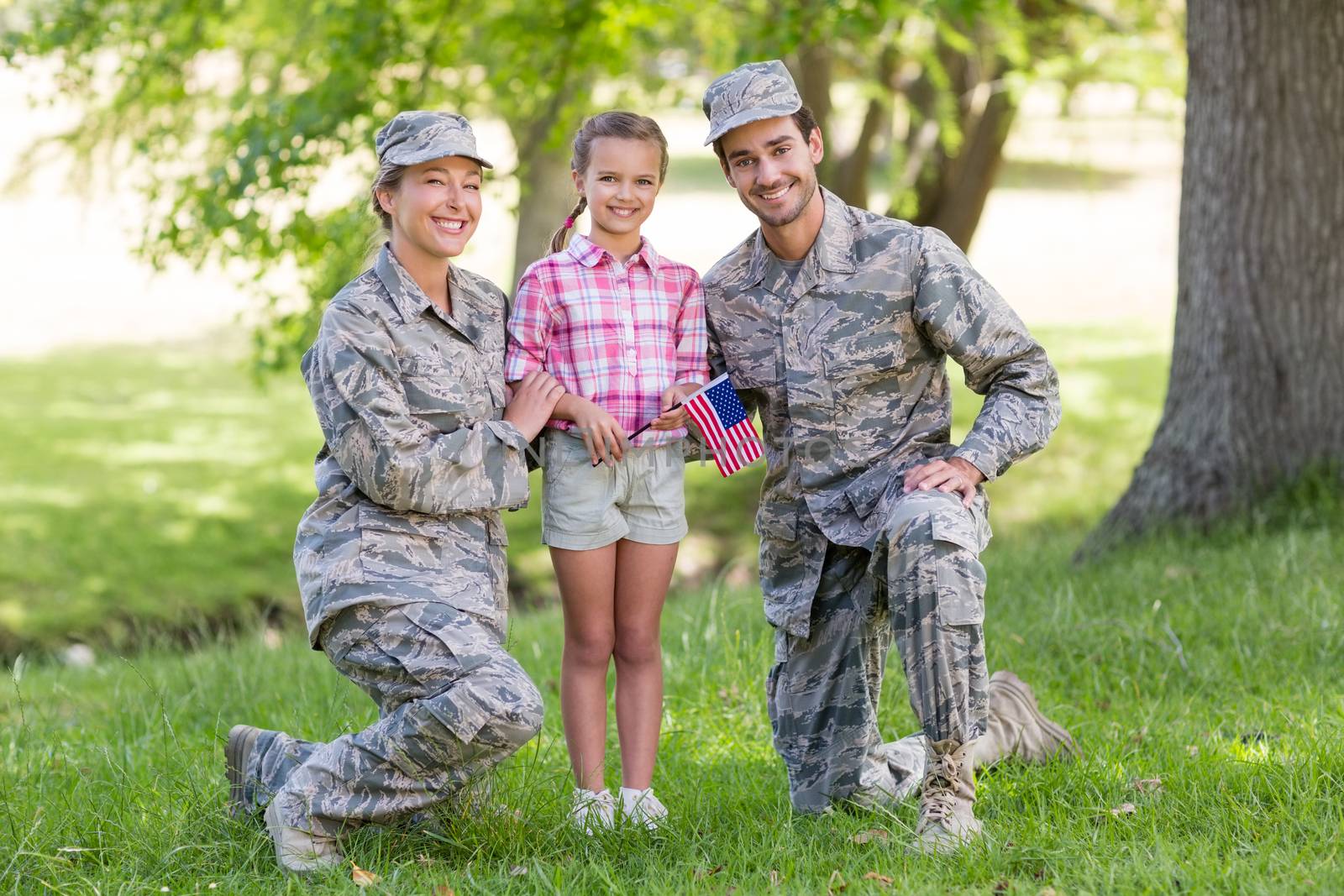 military couple with their daughter in park