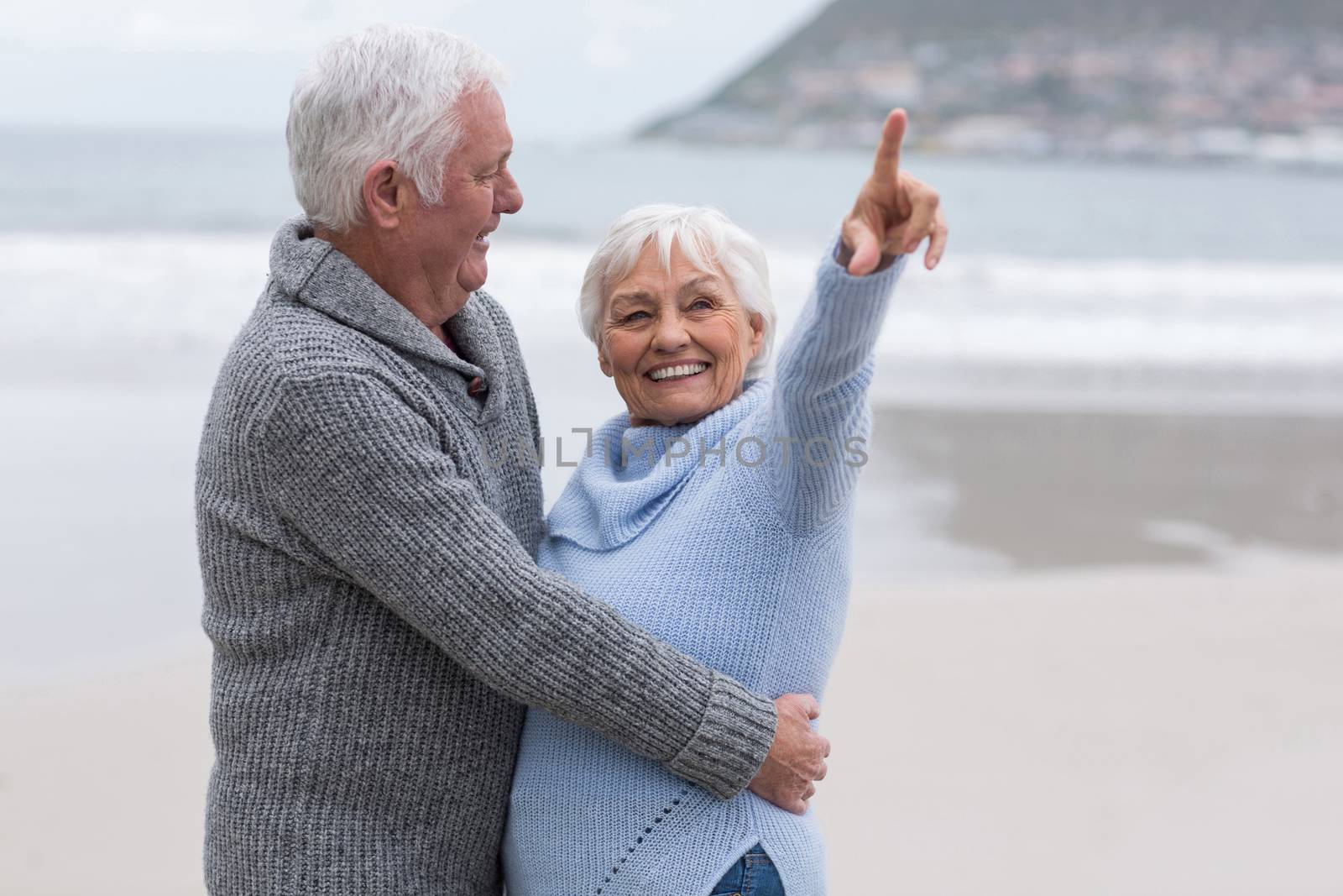 Senior couple standing together on the beach by Wavebreakmedia