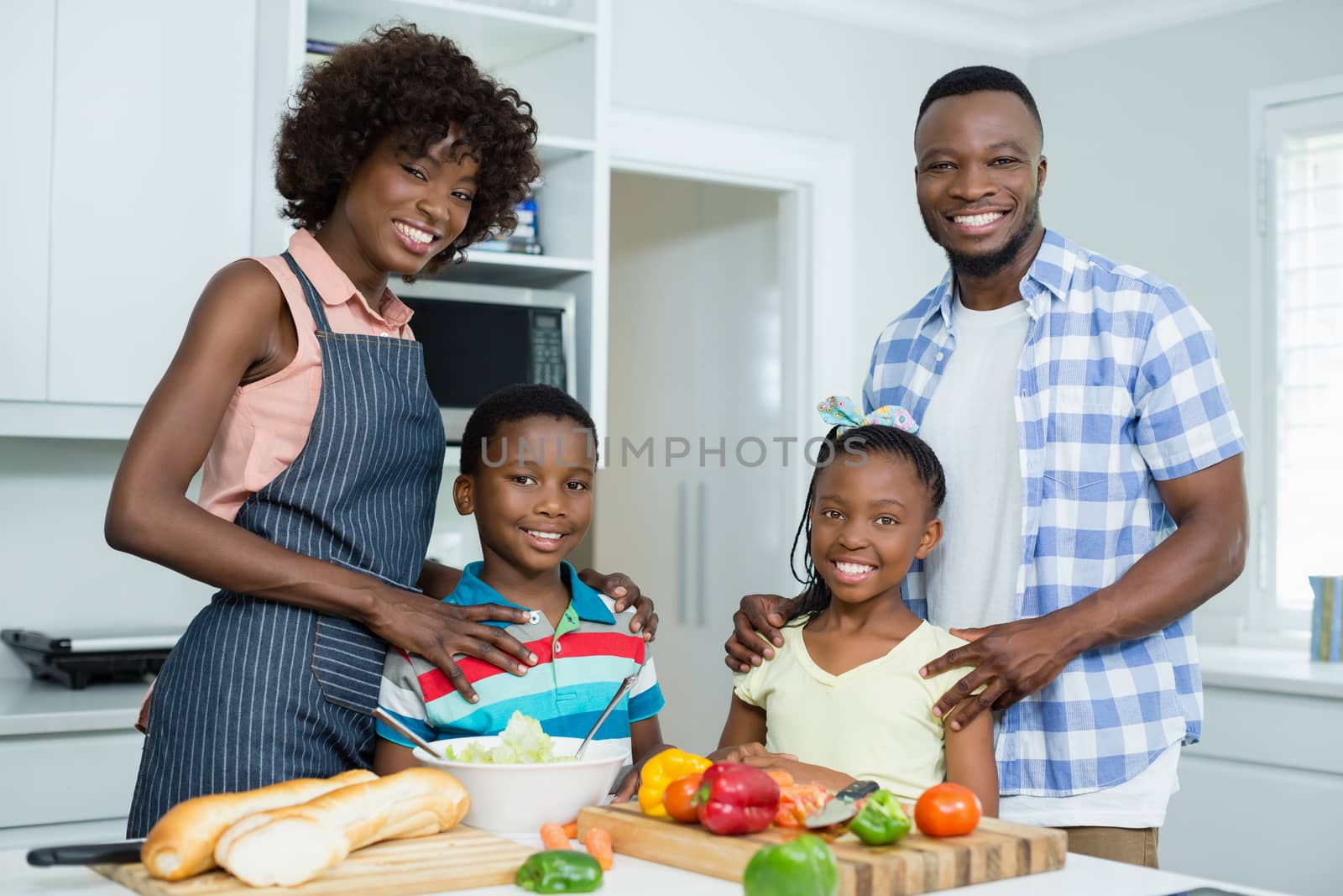 Portrait of parents and Kids standing in kitchen at home