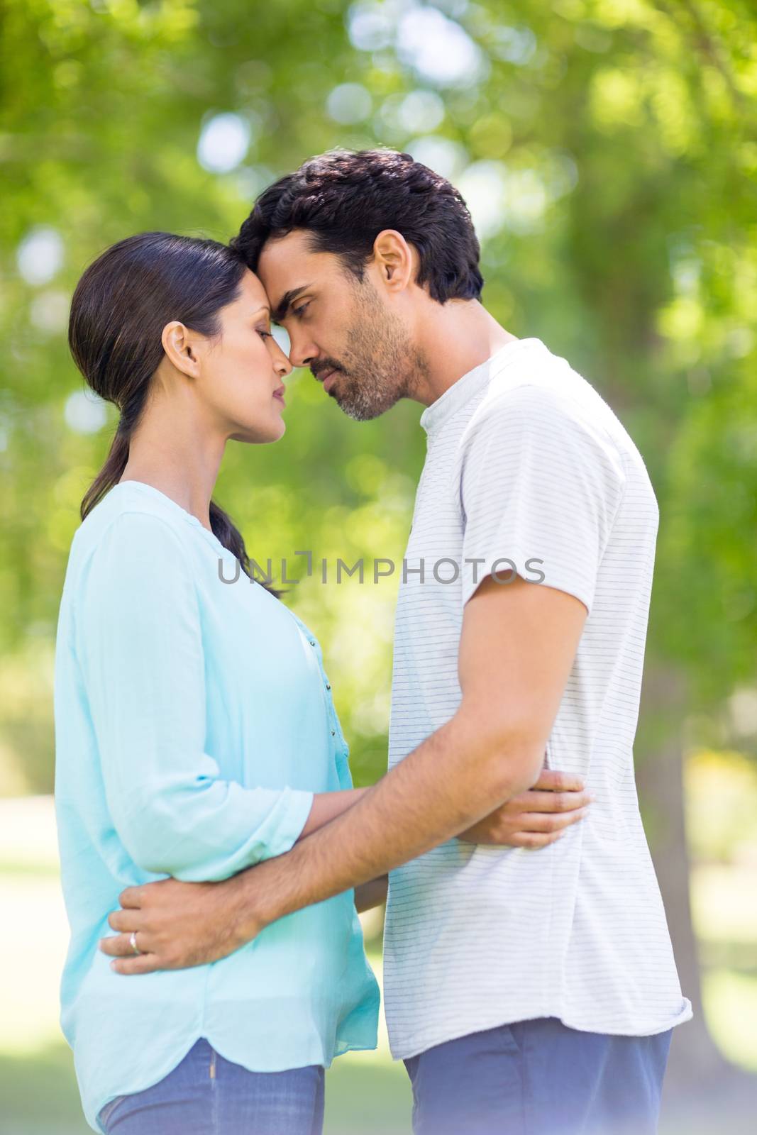 Romantic couple embracing each other in park