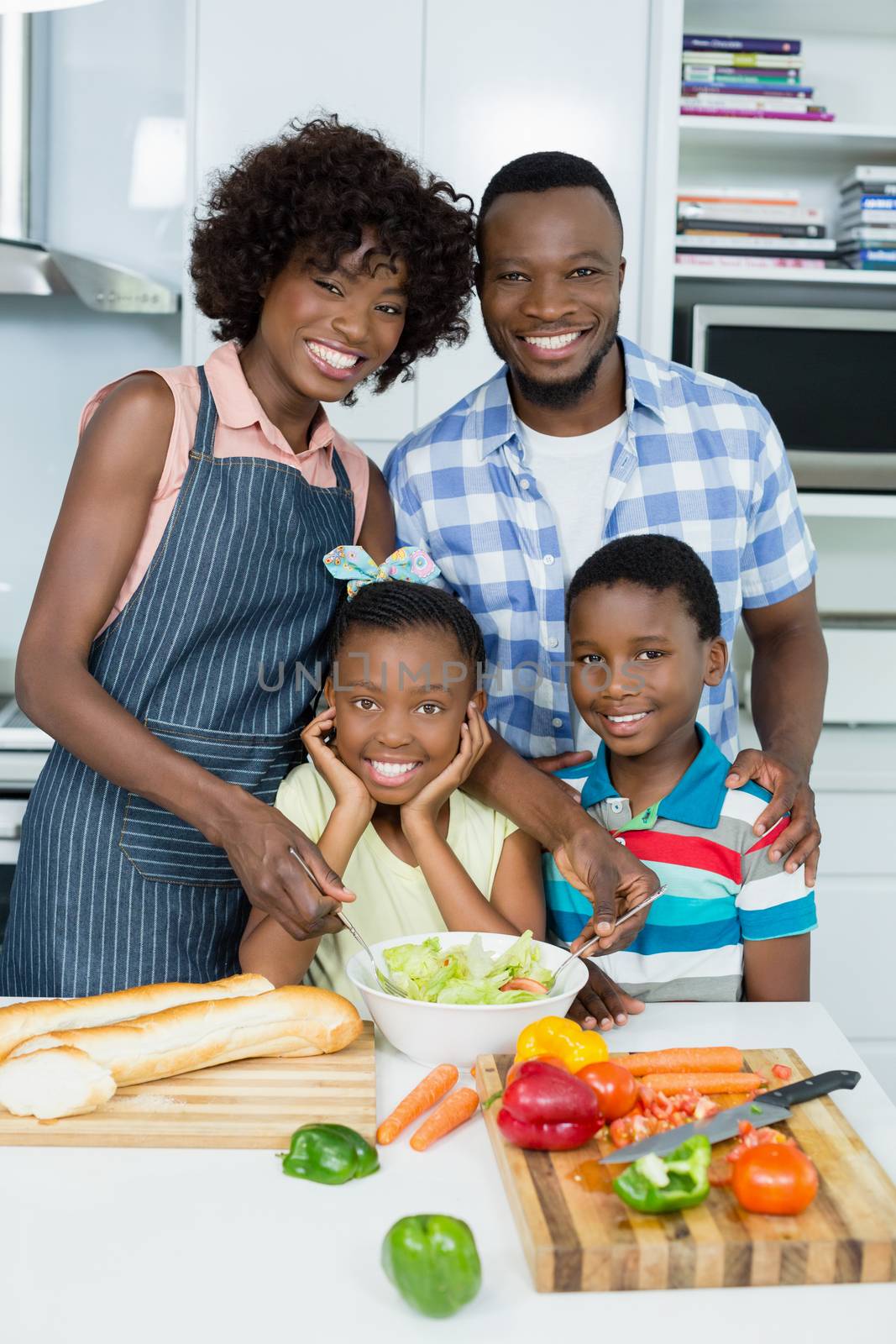 Portrait of parents and Kids standing in kitchen at home