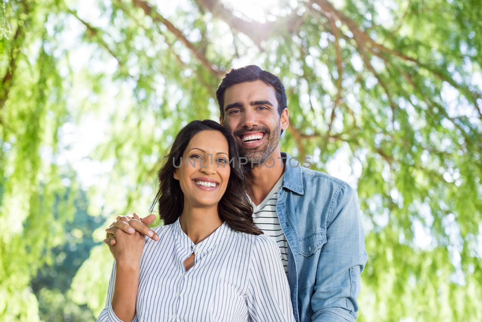 Portrait of couple smiling in park by Wavebreakmedia