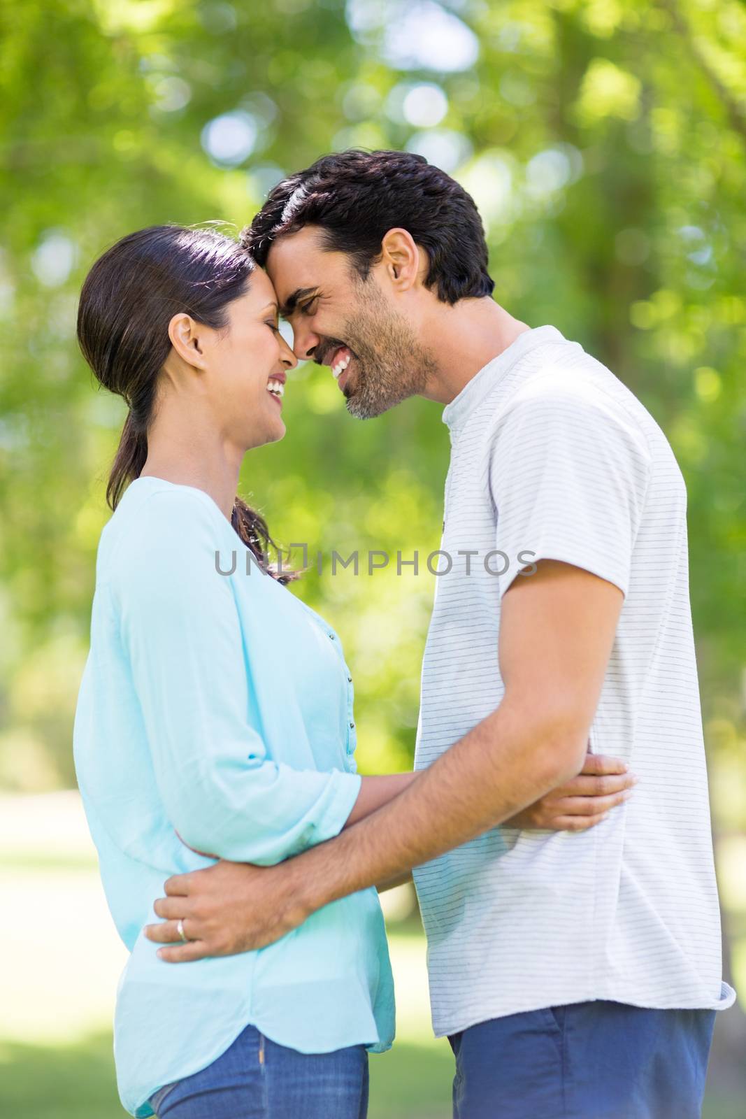 Romantic couple embracing each other in park