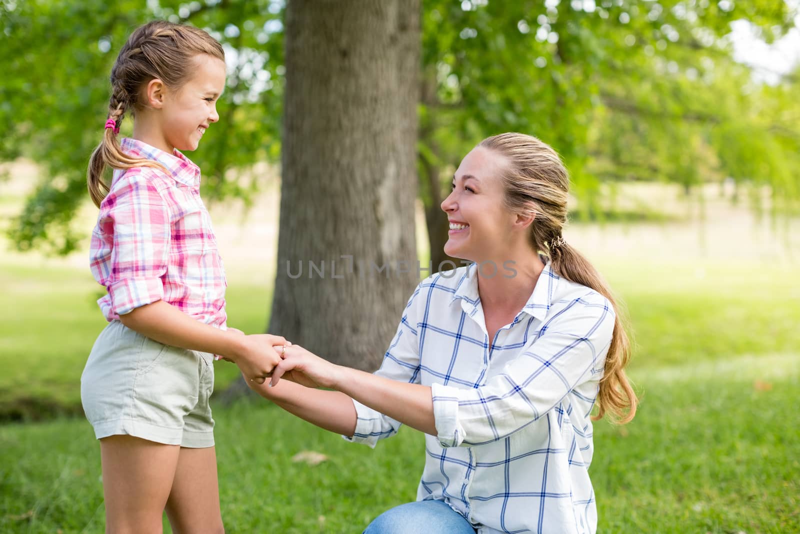 Portrait of a mother holding hands of her daughter in park by Wavebreakmedia