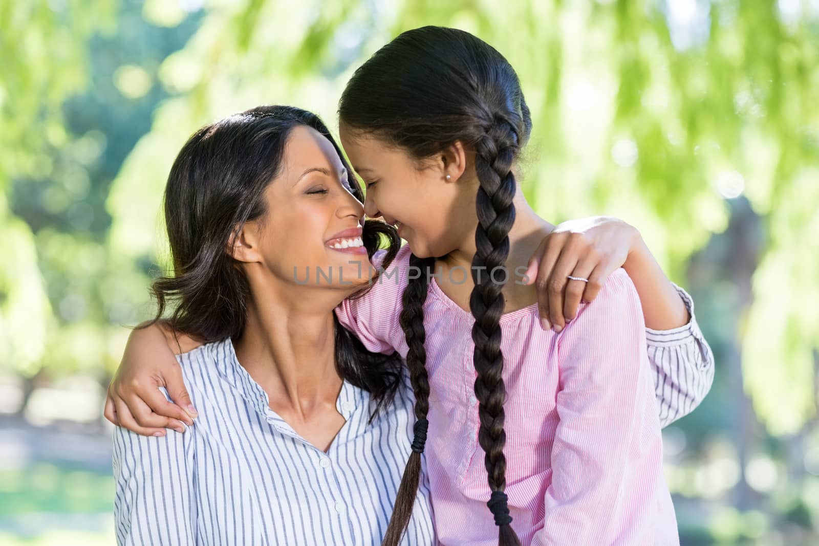 Happy mother embracing her daughter in park