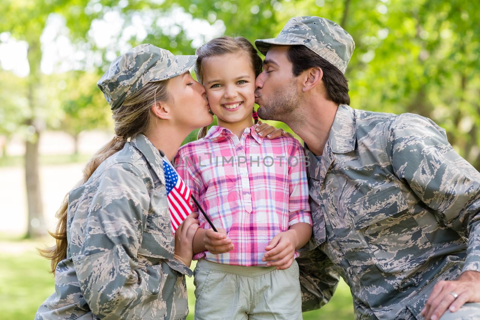 Military couple with their daughter in park on a sunny day