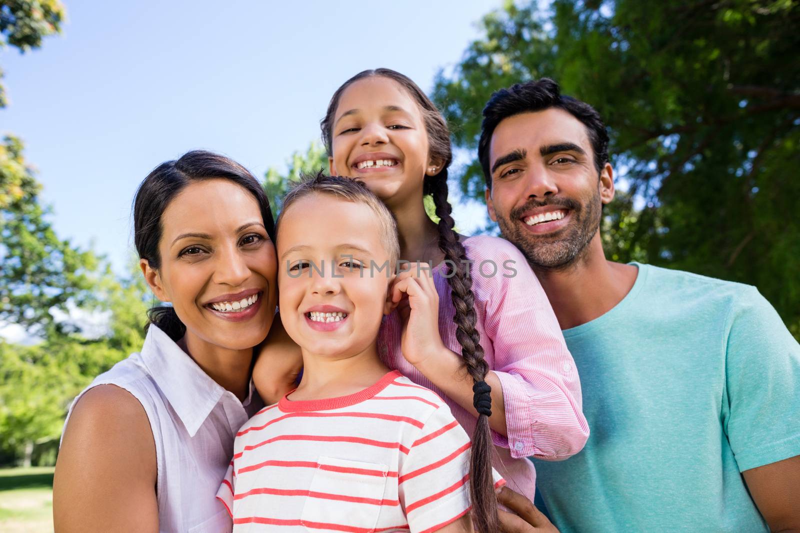 Portrait of happy family in park on a sunny day