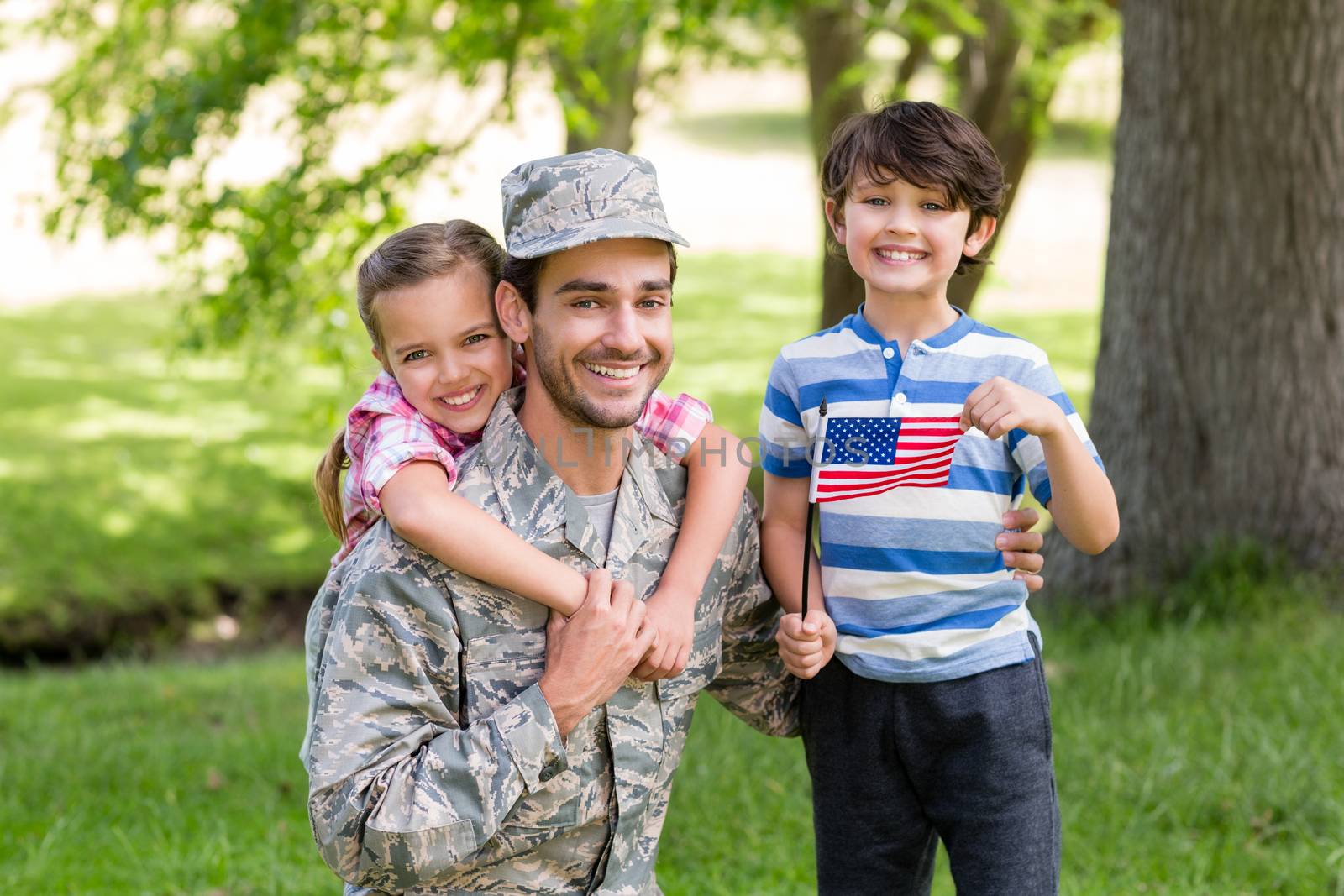 Happy soldier with his son and daughter in park by Wavebreakmedia