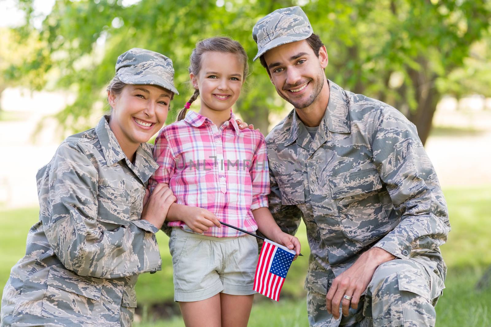 military couple with their daughter in park
