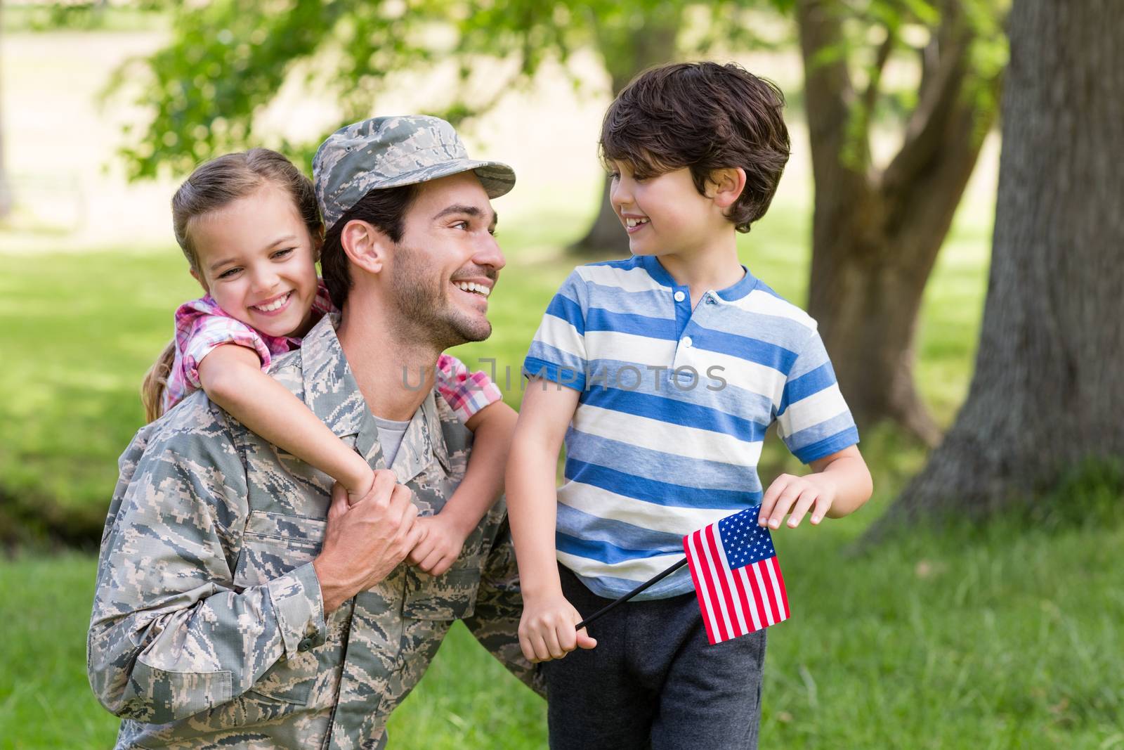 Happy soldier reunited with his son and daughter in park by Wavebreakmedia